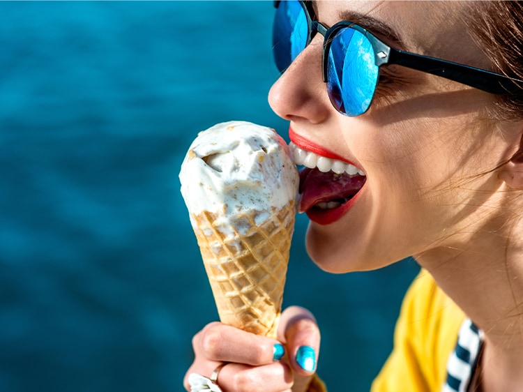 woman smiling while eating ice cream