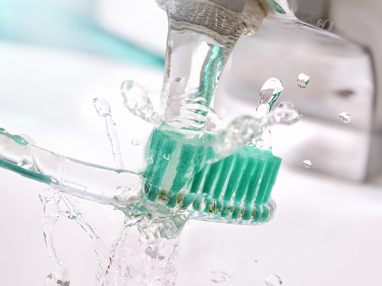 water running on a colgate toothbrush